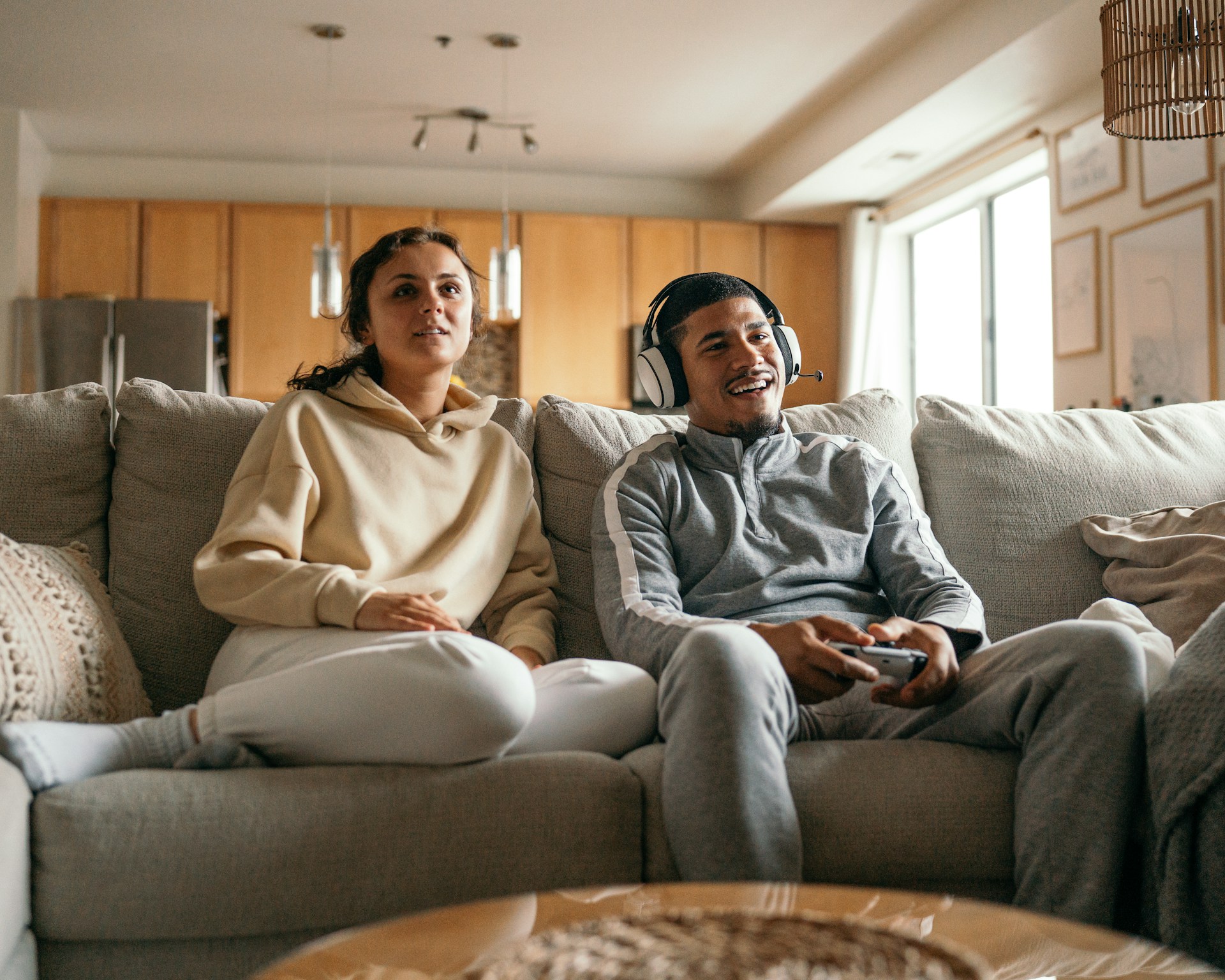 A man with green sleeves enjoying pizza and soda while working on a laptop at home.