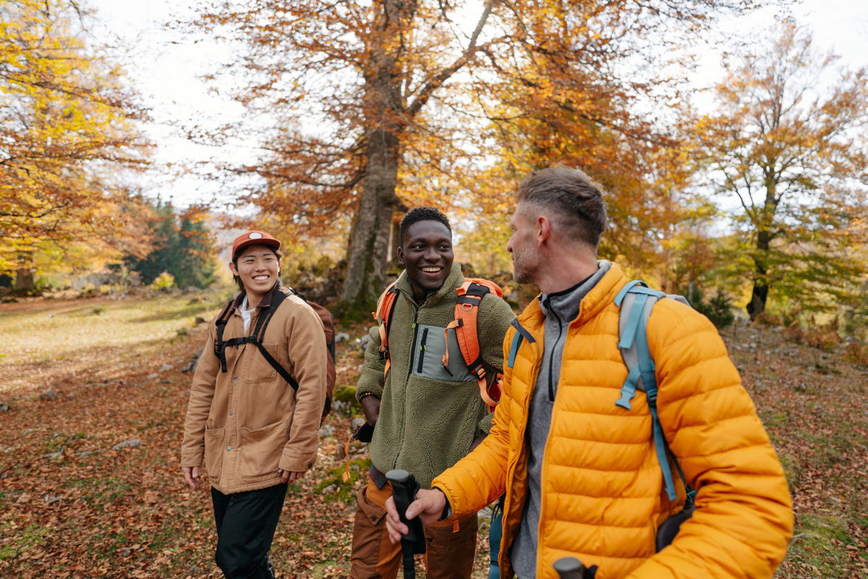 Group of friends cheerfully toasting drinks at a stylish indoor bar.